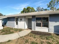 Charming single-story home with a well-maintained yard, textured facade and modern windows at 2052 Sheffield Ct, Oldsmar, FL 34677