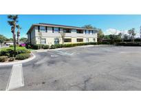 Exterior view of an apartment building with neutral siding and ample parking in front at 552 Golden Raintree Pl, Brandon, FL 33510