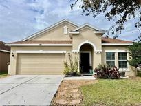 Charming single-story home featuring a two-car garage, neutral paint, and neatly manicured landscaping at 724 Parker Den Dr, Ruskin, FL 33570