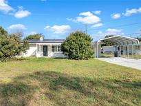 Charming single story home with a well maintained lawn and covered parking at 301 Francis Dr, Apollo Beach, FL 33572
