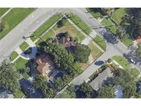 Aerial view shows property lines on a landscaped corner lot with mature trees and a pool at 515 Snell Isle Ne Blvd, St Petersburg, FL 33704