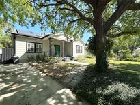 Charming bungalow with a well-manicured front yard, complemented by a large shade tree at 3025 W North A St, Tampa, FL 33609