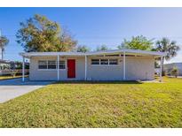 Charming single-story home with a red front door and covered entryway at 1338 Windsor Way, Tampa, FL 33619