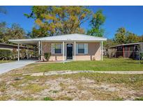 Charming single-story home with a carport and well-maintained front lawn at 3720 E Idlewild Ave, Tampa, FL 33610