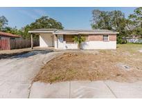 Exterior view of a single-story home with a carport and a partially bricked facade at 1825 134Th St, Largo, FL 33778