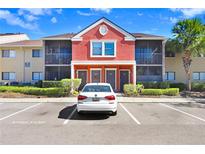 Charming condo building with colorful facade, well-maintained landscaping, and convenient visitor parking at 5729 Baywater Dr # 5729, Tampa, FL 33615