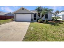 Charming single-story home featuring a two-car garage, well-kept lawn, and tidy landscaping at 3527 65Th Avenue E Cir, Sarasota, FL 34243