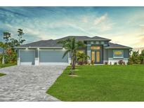 Charming home featuring a three-car garage, well-manicured lawn, and meticulously designed brick driveway at 291 Rotonda S Blvd, Rotonda West, FL 33947