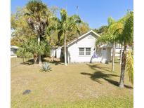 Charming single-story home with lush landscaping, including mature palms, in a sunny location at 744 Myrtle Ave, Venice, FL 34285