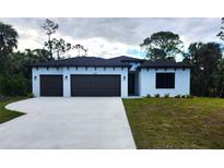 Charming single-story home featuring a two-car garage and a well-maintained lawn at 4313 Appleton Ter, North Port, FL 34286