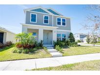 Charming two-story home boasts a neatly landscaped front yard, enhancing its curb appeal and welcoming ambiance at 13001 Pennybrook Dr, Riverview, FL 33579