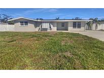 Charming single-story home featuring a well-maintained lawn and classic architectural details at 1540 David Pl, Englewood, FL 34223