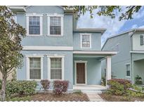 Charming blue two-story home with white trim and a welcoming front porch at 6160 Castleton Hollow Rd, Riverview, FL 33578