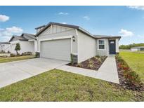 Beautiful one-story home with green lawn and manicured flowerbeds at 3561 Moscato Dr, Brooksville, FL 34602
