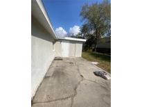 Concrete patio area with exterior door, adjacent to house, needing some repair at 6340 Westport Dr, Port Richey, FL 34668