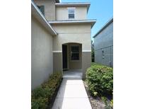 Inviting front entrance with covered porch and neutral-tone exterior at 6339 Magnolia Trails Ln, Gibsonton, FL 33534