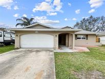 Charming single-story home featuring an attached garage and covered entryway at 5700 Venetian Ne Blvd, St Petersburg, FL 33703