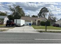 Charming single-story home featuring a two-car garage and a well-maintained front yard at 9476 Spring Hill Dr, Spring Hill, FL 34608