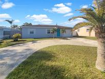 Charming single-story home with a well-maintained lawn and a circular driveway at 8340 75Th Pl, Seminole, FL 33777