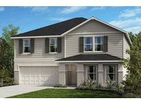 Charming two-story home with gray siding, black shutters, well-manicured lawn, and attached two-car garage at 37630 Mackenzie Dr, Zephyrhills, FL 33540