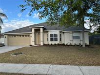 Well-maintained single-story home featuring a manicured lawn and neutral-tone exterior at 4845 Post Pointe Dr, Sarasota, FL 34233
