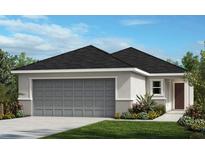 Charming single-story home featuring a gray garage door, modern architectural details and professionally landscaped front yard at 2194 Nass Rd, Zephyrhills, FL 33540