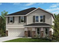 Charming two-story home with a manicured lawn, covered entrance, attached garage, and beautiful landscaping at 10955 Bluestem Cv, Parrish, FL 34219