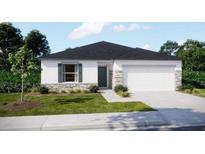 Charming one-story home with stone accents, a two-car garage, and a well-manicured lawn at 2258 Sulstone Dr, Punta Gorda, FL 33983