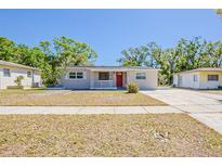Charming single-story home with a well-maintained lawn and a welcoming red front door at 2500 Erie S St, St Petersburg, FL 33712