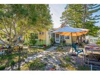 Cozy home with front yard shaded by mature trees, offering a tranquil and private outdoor space at 5224 29Th S Ave, Gulfport, FL 33707