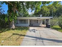 Charming single-story home with a covered carport and mature landscaping at 6405 Gainsboro Dr, Port Richey, FL 34668