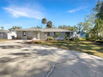 Charming single-story home boasting a well-manicured lawn and a spacious driveway at 2827 Silk Oak Dr, Sarasota, FL 34232