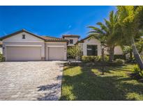 Charming home with a tile roof, three-car garage, and well-manicured landscaping at 17936 Polo Trl, Bradenton, FL 34211