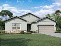 Charming single-Gathering home with stone accents, a well-manicured lawn, and an attached two-car garage at 36183 Canelli Way, Dade City, FL 33523