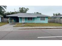 Charming single-story home with a carport and quaint front yard at 2155 Webber St, Sarasota, FL 34239