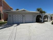 This property features a two car garage with arched entry to the side at 3747 Floramar Ter, New Port Richey, FL 34652