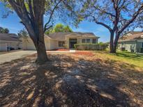 Charming single-story home featuring a well-maintained front yard and a classic exterior design at 8080 Spanish Oak Dr, Spring Hill, FL 34606