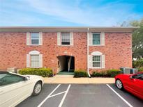 Two-story brick building with white shutters, manicured landscaping, and convenient parking at 3425 41St S Ter # 202, St Petersburg, FL 33711