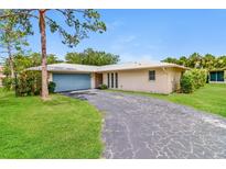 Charming single-story home with a well-maintained lawn, long driveway, and welcoming curb appeal at 4337 Marine Pkwy, New Port Richey, FL 34652