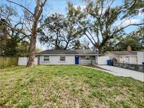 Charming single-story home with a well-manicured lawn and mature trees in a serene setting at 4907 E Clifton St, Tampa, FL 33610