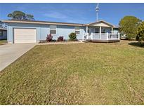 Charming home with a spacious front yard, inviting porch, and attached one car garage at 6804 11Th W St, Bradenton, FL 34207