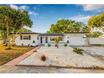 Charming single-Gathering home with well-maintained landscaping and a lovely walkway leading to the entrance at 5980 32Nd N Ave, St Petersburg, FL 33710