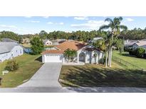 Beautiful home showcasing a well-manicured lawn, a long driveway, and a two-car garage at 4320 Genesee Ln, New Port Richey, FL 34655