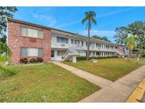 Multi-Gathering building featuring brick facade and white stairs, surrounded by well-maintained landscaping at 2353 Shelley St # 8, Clearwater, FL 33765