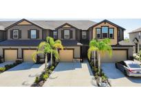 Inviting townhouse with modern design, private garages, and lush landscaping create desirable curb appeal at 11826 Sky Acres Ter, Bradenton, FL 34211