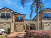 Inviting two-story townhome with charming curb appeal and paver driveway at 1998 Milkweed Trce, Lutz, FL 33558
