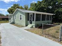 Charming home with a screened porch and freshly painted exterior and driveway at 3615 E Grove St, Tampa, FL 33610