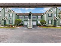Inviting condominium with pleasing curb appeal, tidy landscaping, and attached garage at 10520 Windsor Lake Ct # 10520, Tampa, FL 33626