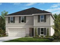 Charming two-story home with a manicured lawn and attached two-car garage at 37531 Williamette Way, Zephyrhills, FL 33540