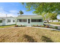 Charming home featuring a cozy screened porch and well-maintained front yard, perfect for relaxing outdoors at 514 Fitzhugh Ave, Punta Gorda, FL 33950